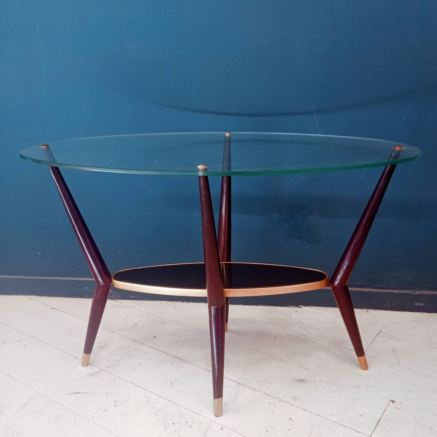 Tavolino da caffè vintage ovale con due ripiani in vetro, gambe in legno e borchie in ottone risalente agli anni '50.